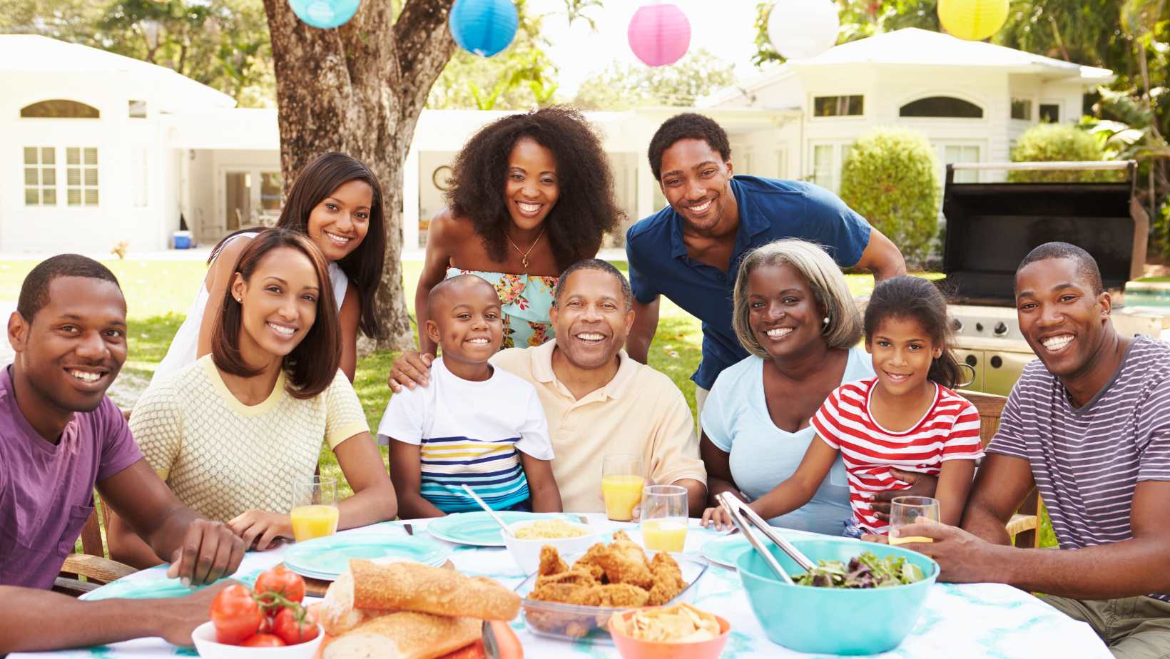 Large family eating together at a set table outdoors